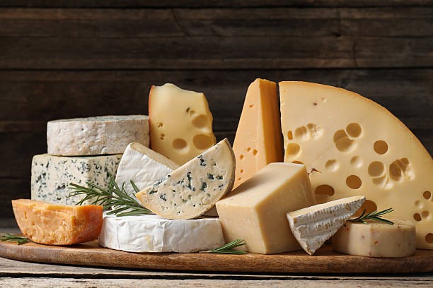 Various types of cheese displayed on cutting board
